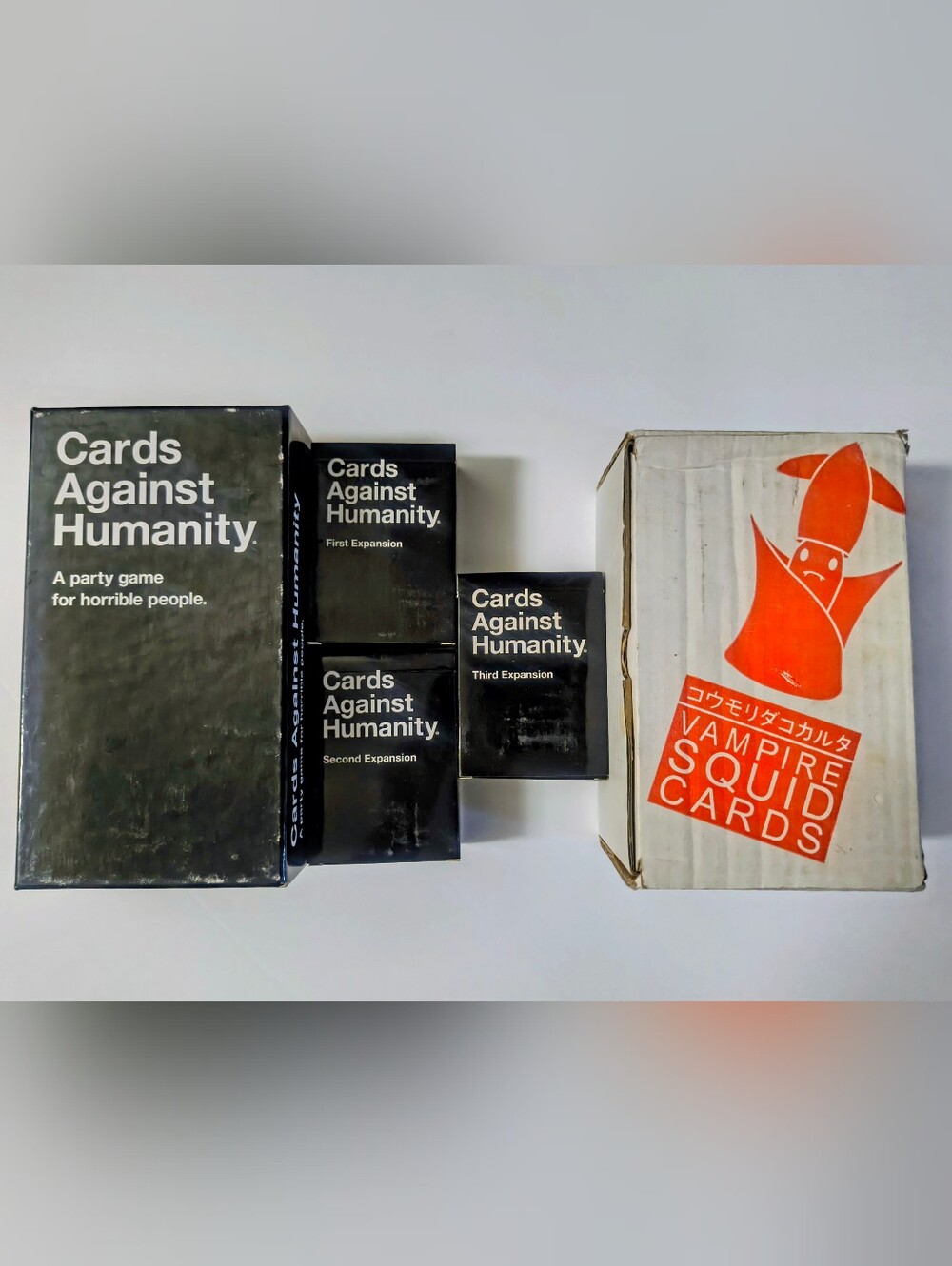 Cards Against Humanity + Crabs Adjust Humidity Game Card Sets.
